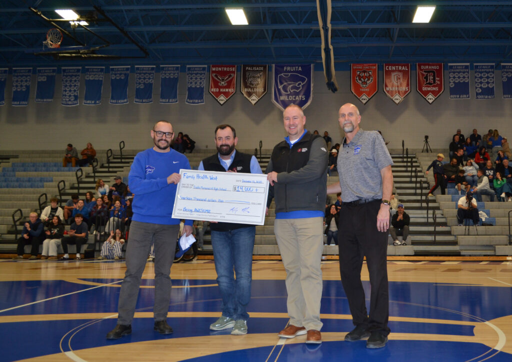 FWH CEO Dr. Klein and Senior Director of Marketing Eric Mello at Frutia Monument High School Basketball game