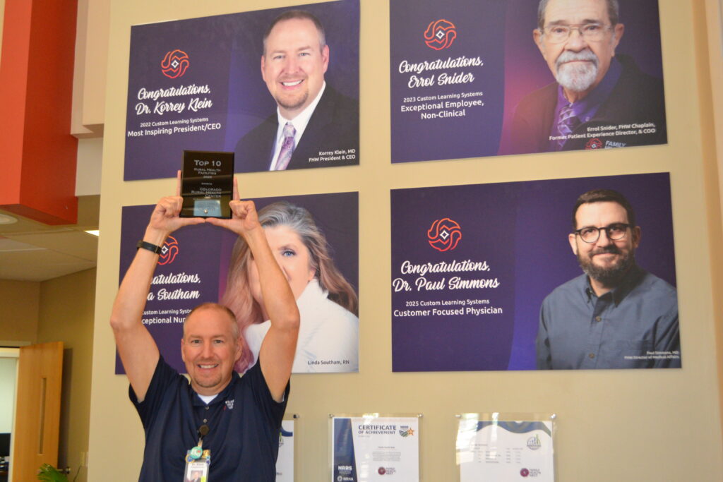 FHW CEO Dr. Klein holds the Top 10 Rural Hospital Award in FHW Hospital in Fruita, CO.