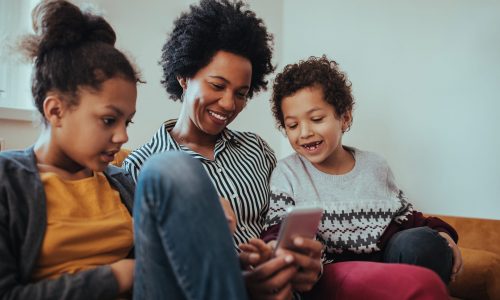 Family of three using modern technology at home
